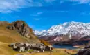 Bergdorf im Engadin mit schneebedeckten Bergen im Hintergrund.