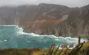 Blick auf die steilen Klippen und das tosende Meer an der irischen Küste.